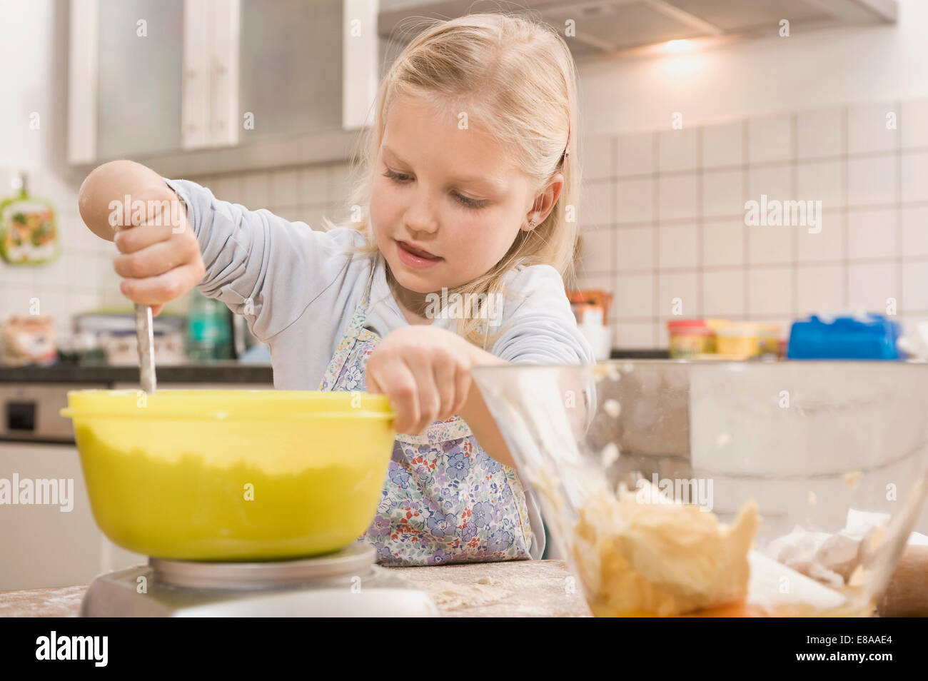 Girl mixing flour in bowl for cookies Stock Photo
