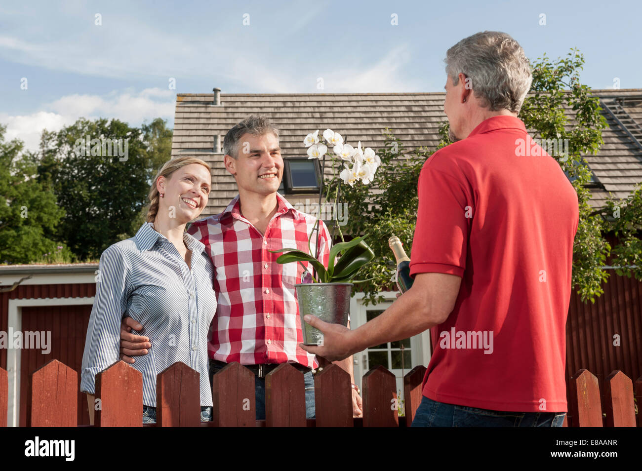 Young couple new owners neighbour greeting Stock Photo