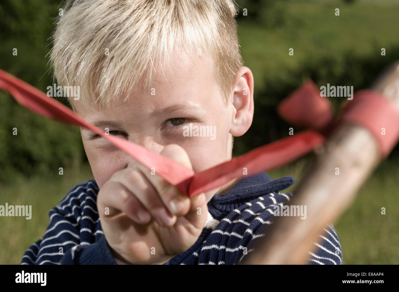 Close up blond boy holding slingshot Stock Photo Alamy