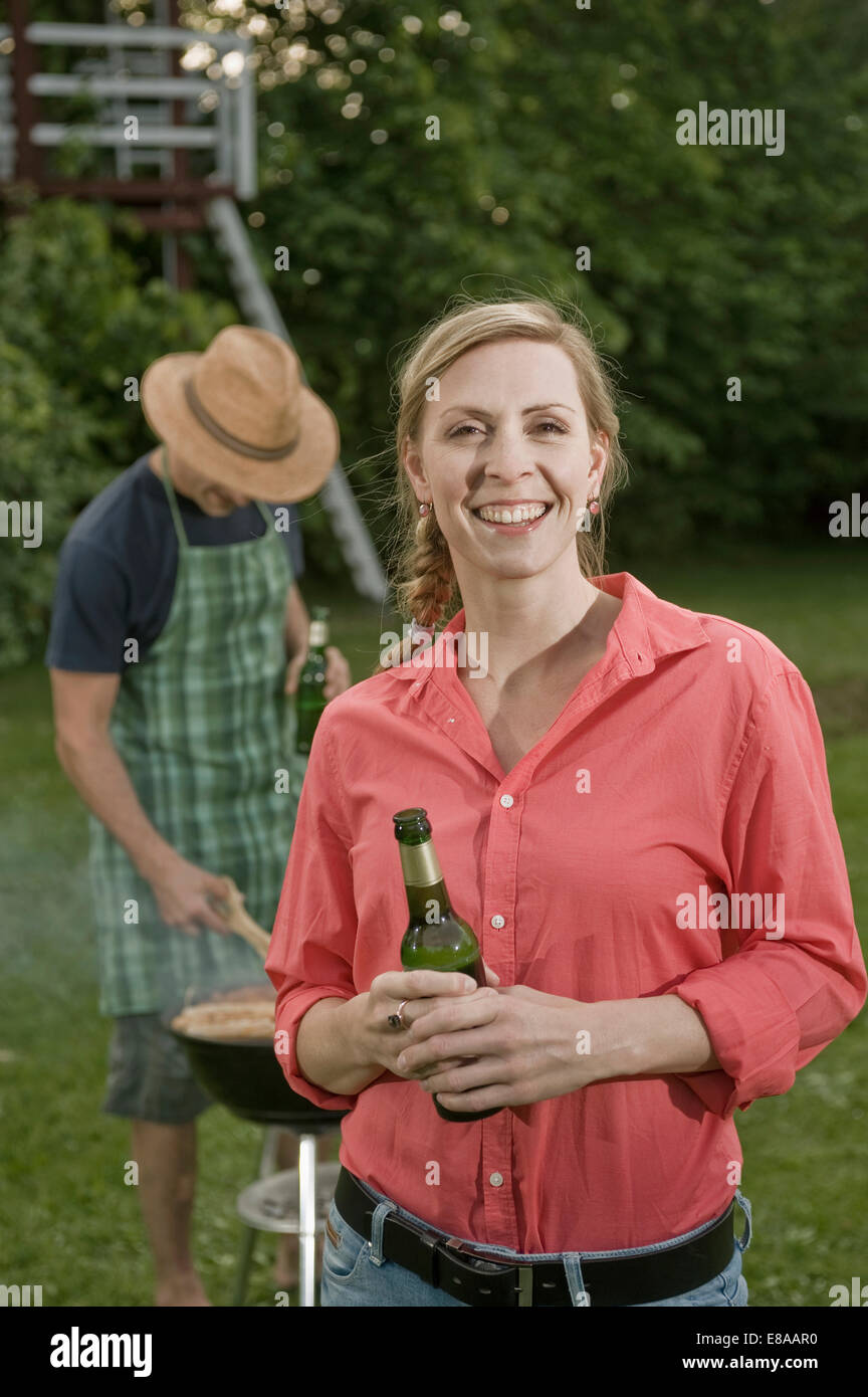Portrait young woman man barbecue garden Stock Photo - Alamy