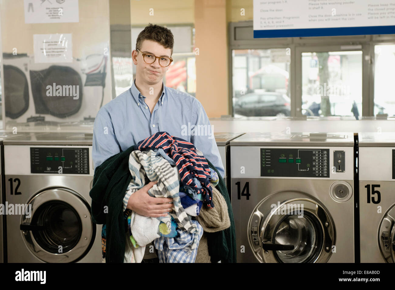 Portrait of young man with laundry Stock Photo Alamy