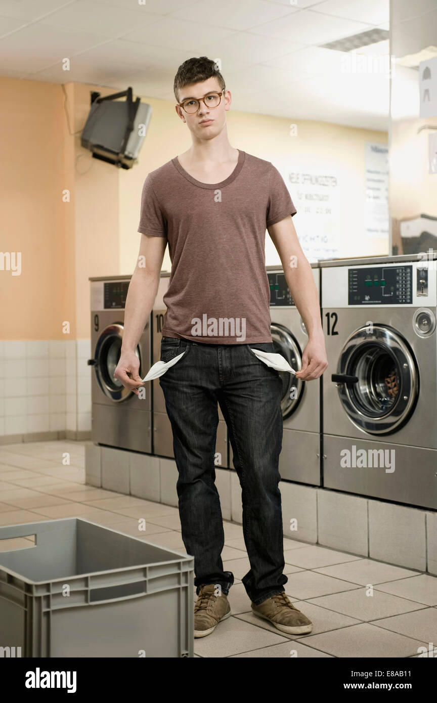 Young man pulling his empty pockets Stock Photo