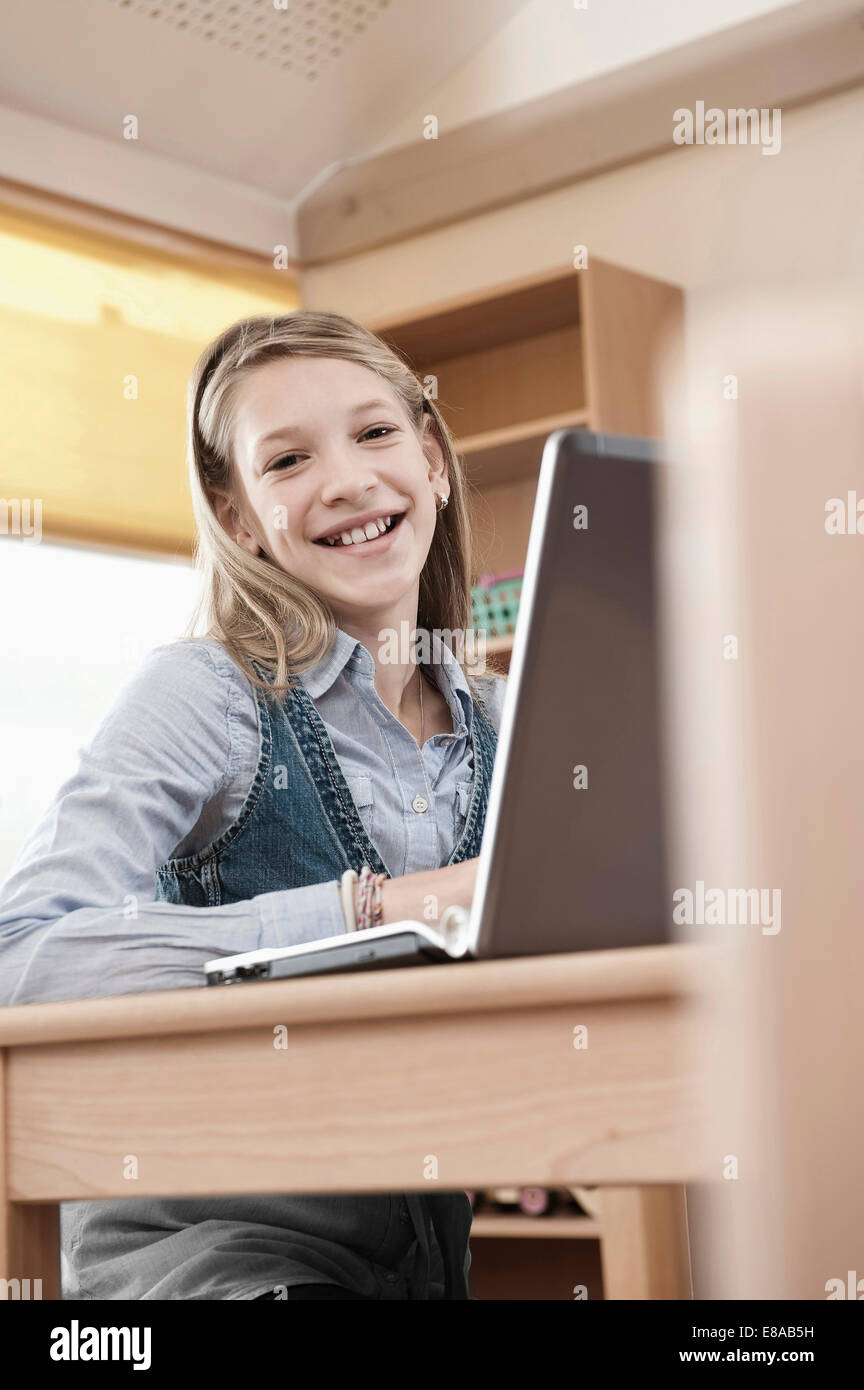 Smiling schoolgirl with laptop Stock Photo - Alamy