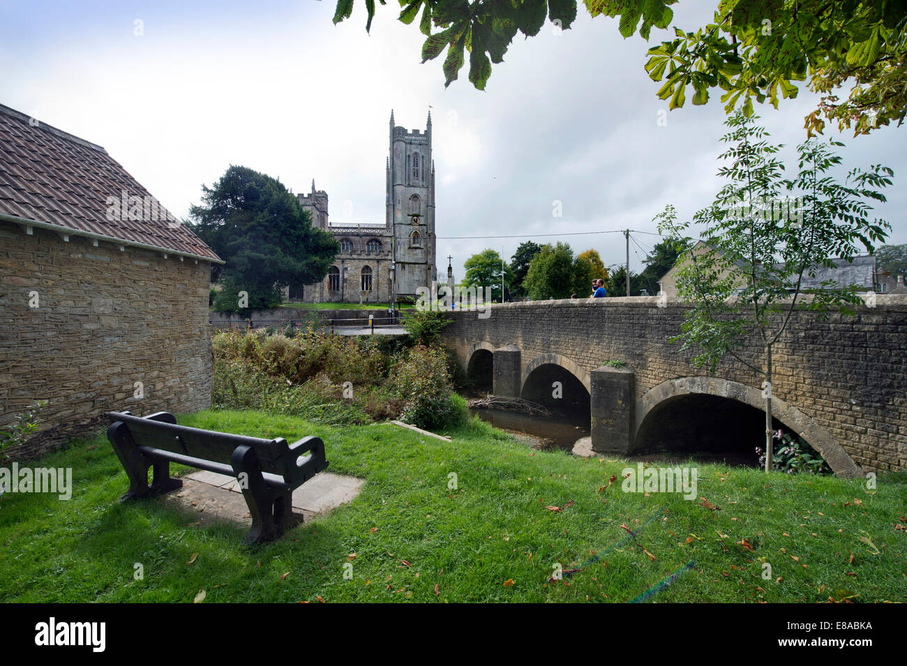 Bridge over the River Brue and the Church of St. Mary in the Somerset village of Bruton UK Stock Photo