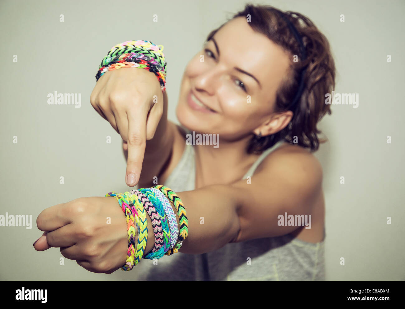 Young girl showing off rainbow loom band bracelets on her wrist Stock Photo  - Alamy