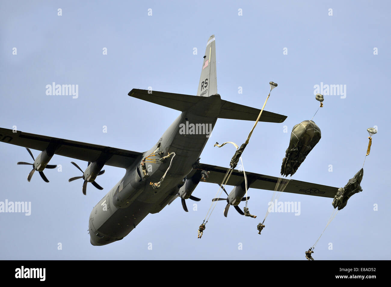 U.S. Army Paratroopers with the 173rd Brigade Support Battalion, 173rd Airborne Brigade Combat Team, conduct an airborne operation with T-11 parachutes from a C-130 Hercules aircraft at Juliet Drop Zone in Pordenone, Italy, Sept. 24, 2014. The C-130 Hercu Stock Photo
