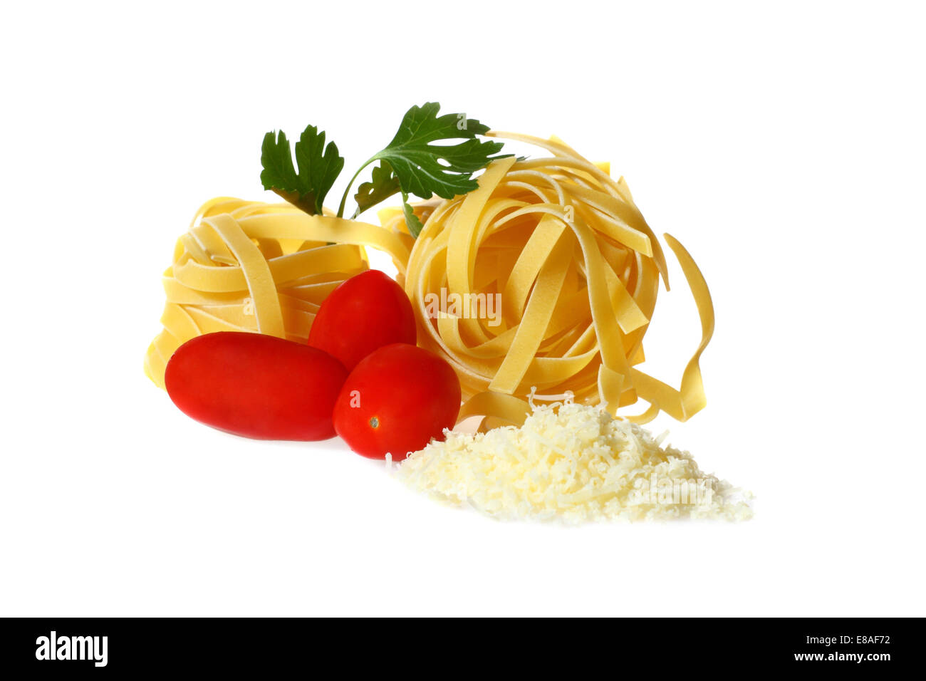 Pasta, tomatoes and grated cheese isolated on white background with shadow Stock Photo