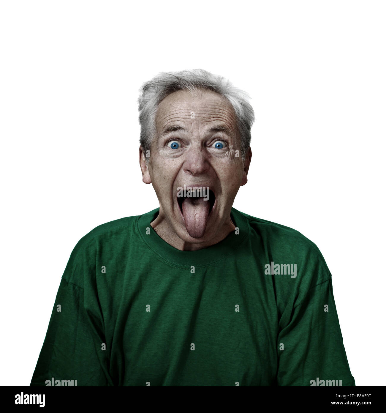 Mad looking senior male shows tongue. Grunge darkened portrait isolated on white background. Wild and crazy grandpa Stock Photo