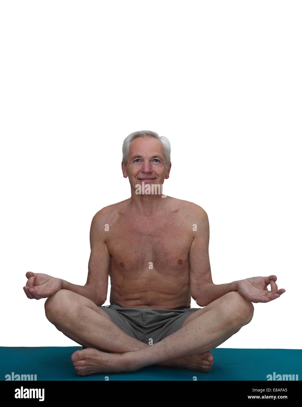 Yogi man sits in lotus position on mat isolated on white background with copy space Stock Photo