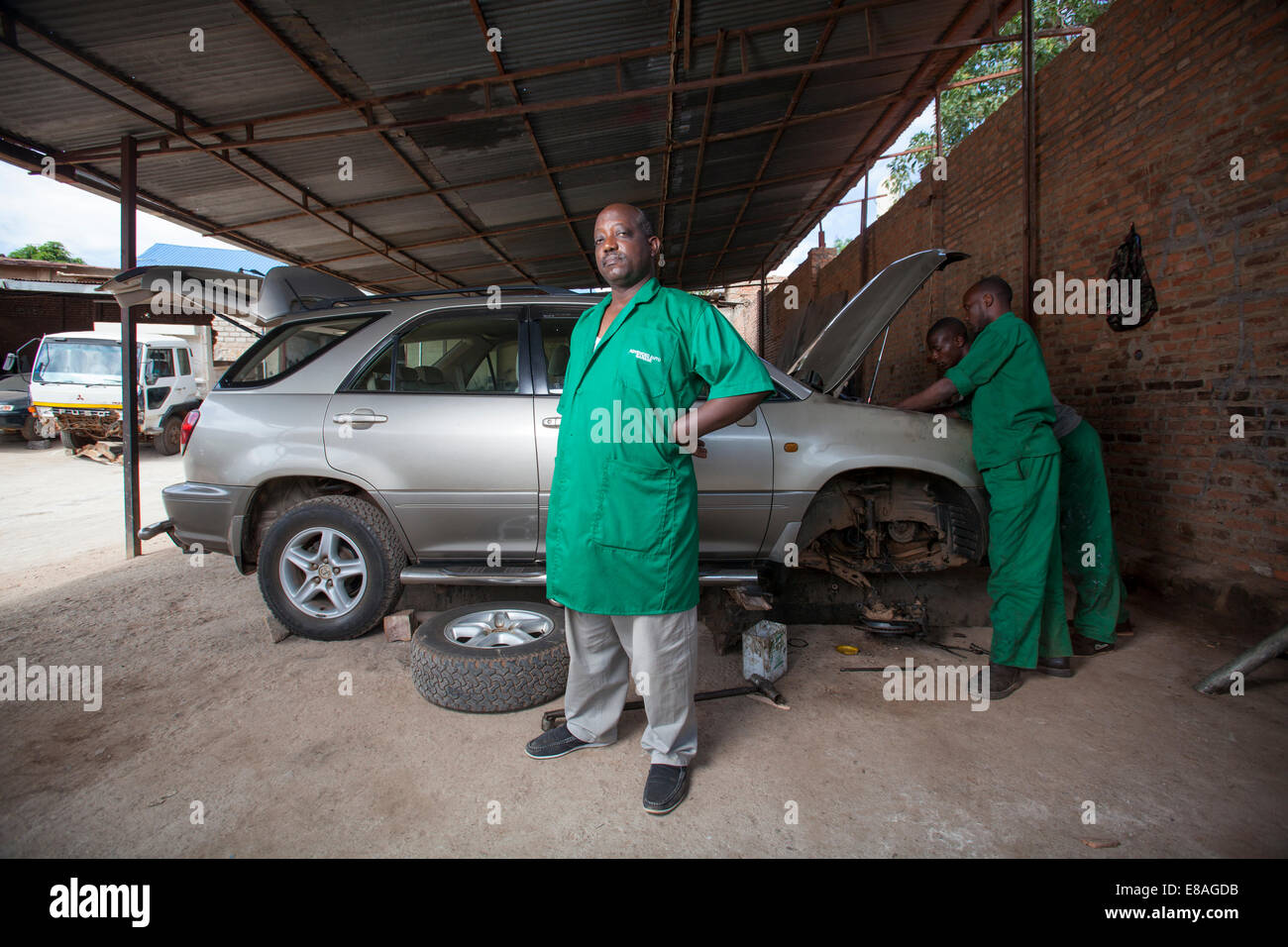 Rwandan mechanic and entrepreneur poses at his garage, Kigali, Rwanda Stock Photo
