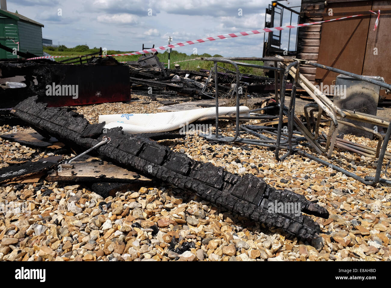 Beach Huts destroyed by fire at Calshot beach hampshire near Southampton in a Beach Watch area zone Stock Photo