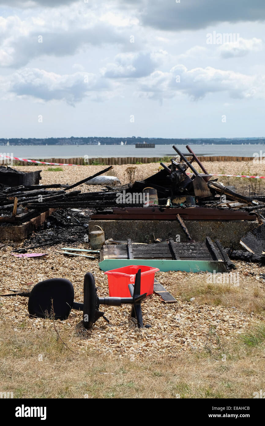 Beach Huts destroyed by fire at Calshot beach hampshire near Southampton in a Beach Watch area zone Stock Photo