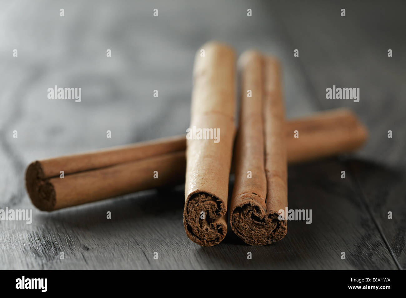 cinnamon sticks on old table, rustic oak table Stock Photo