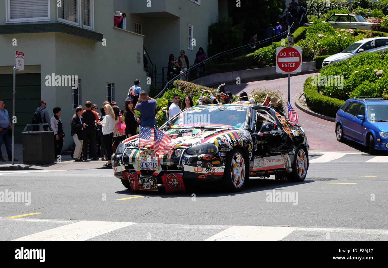 A 49ers fans car comes out of Lombard Street in San Francisco California Stock Photo
