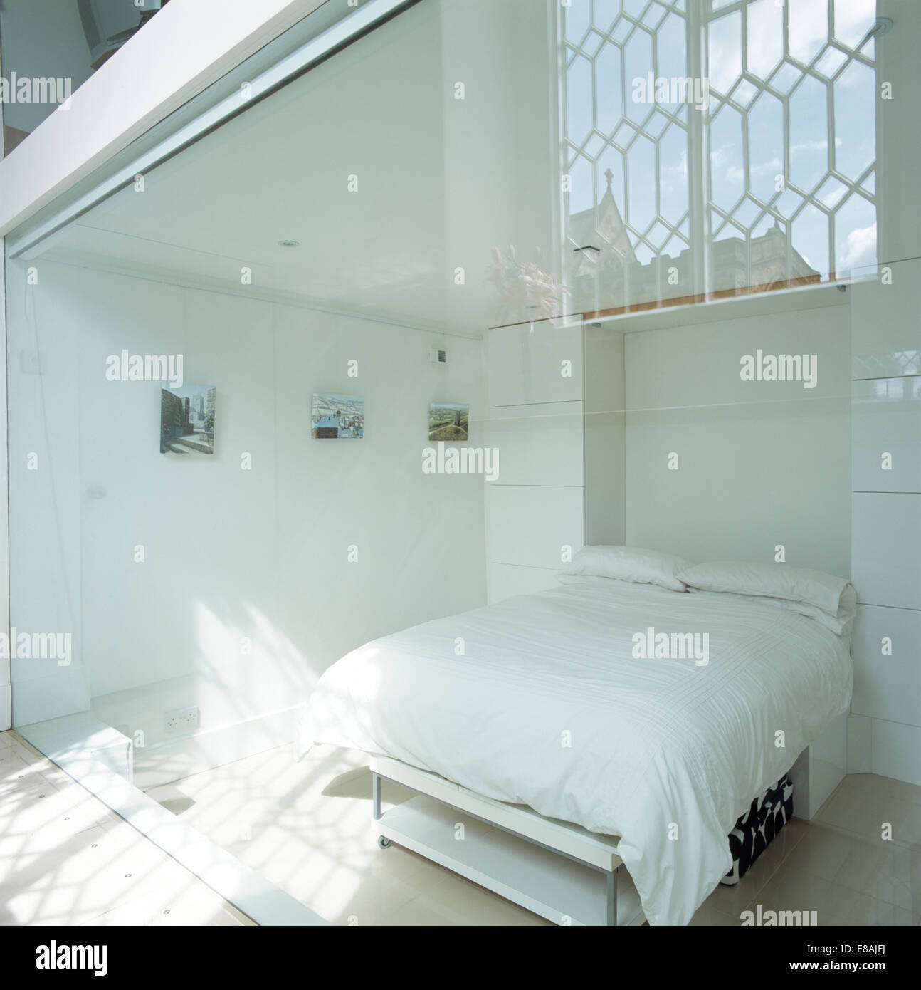 White Pillows And Duvet On Bed In Modern White Bedroom With