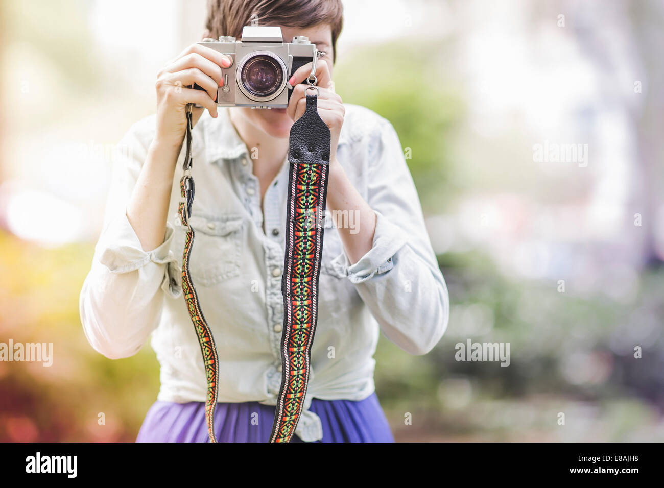 Young woman taking a photograph Stock Photo