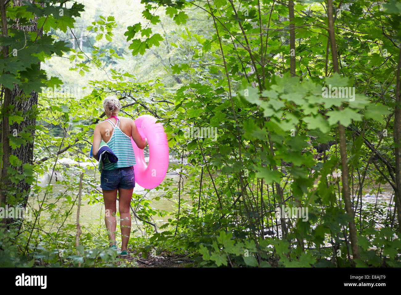 Hiker in forest with inflatable ring Stock Photo