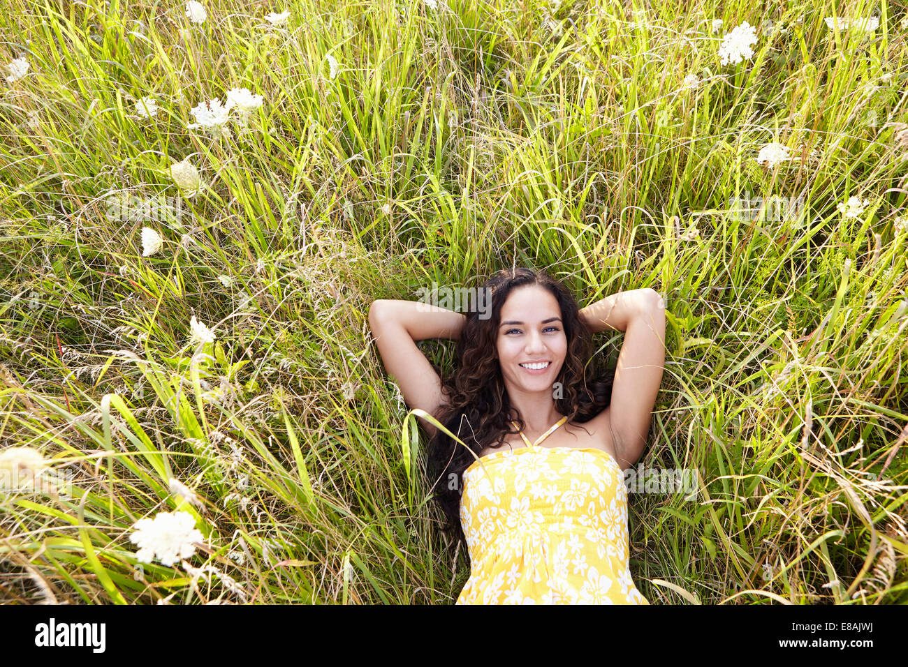 Woman in field of wildflowers Stock Photo