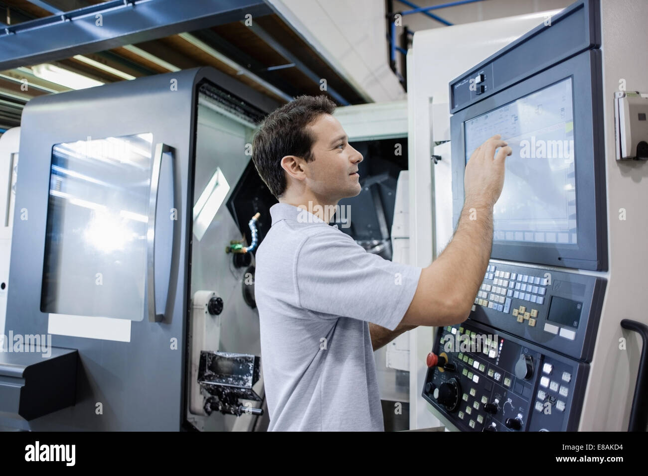 Engineer working in CNC precision engineering Stock Photo