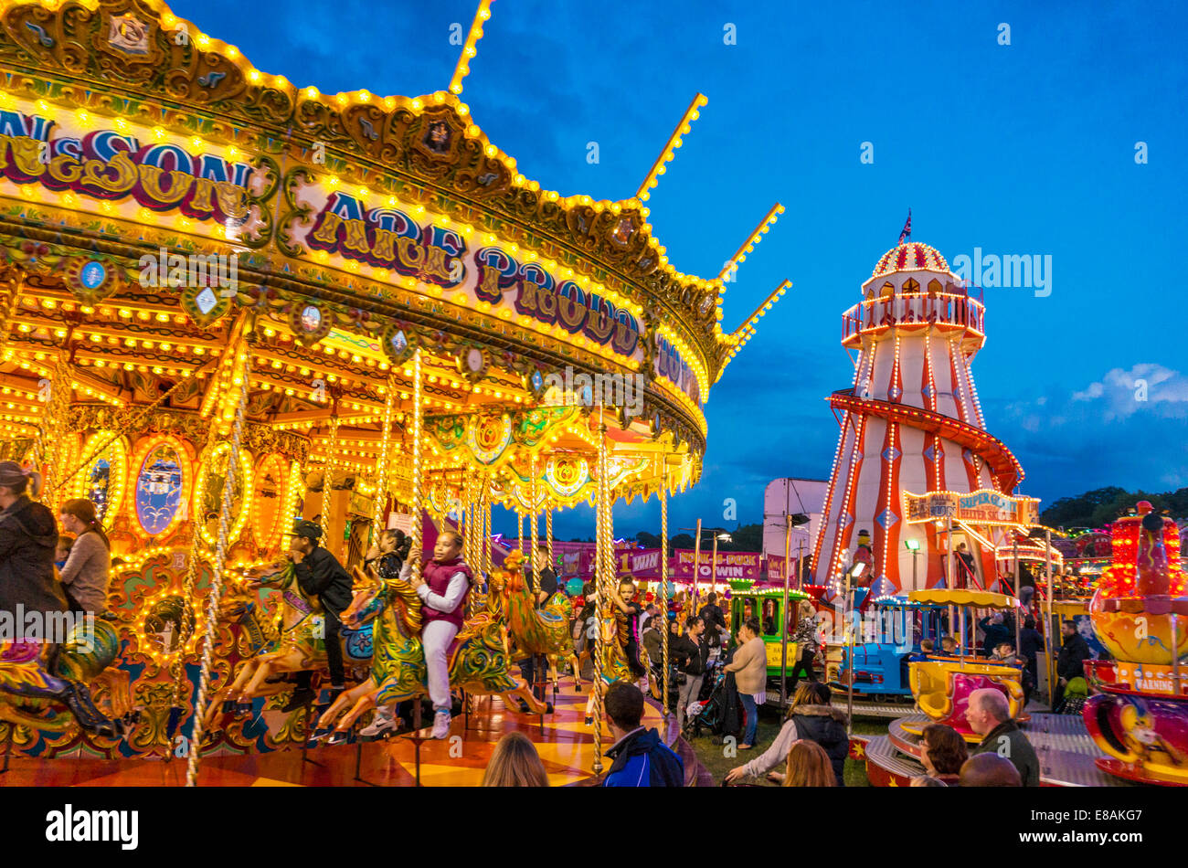 merry go round and helter skelter at night at the Nottingham Goose fair Nottingham East midlands Nottinghamshire gb uk eu europe Stock Photo