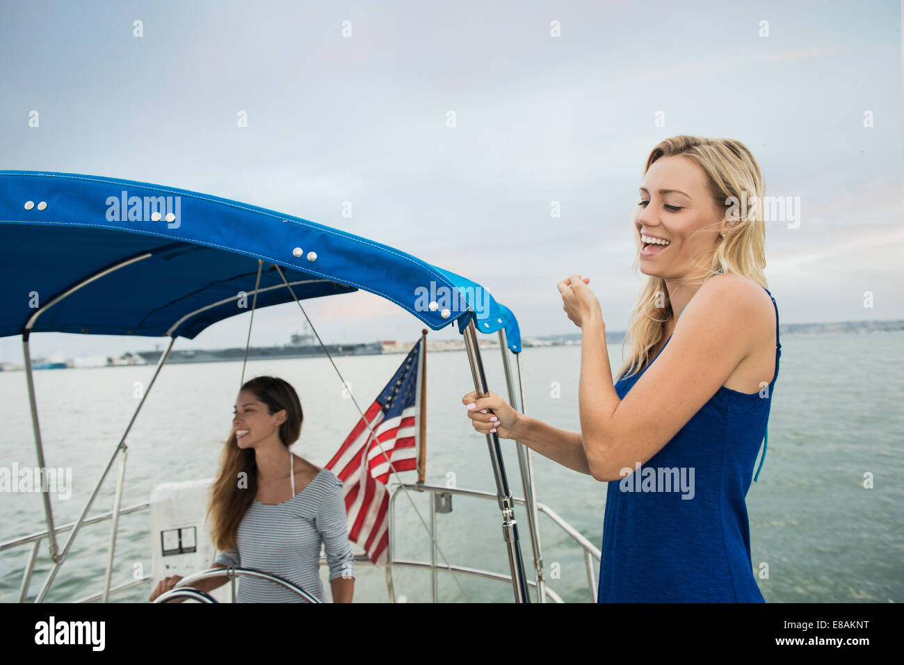 Two women on sailing boat laughing Stock Photo