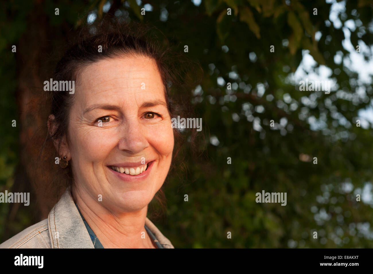 Portrait of smiling mature woman in woodland Stock Photo - Alamy