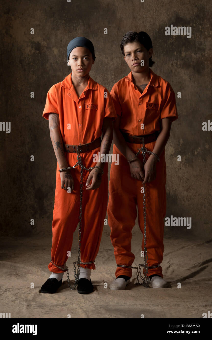 Studio portrait of two boys in handcuffs and chains Stock Photo