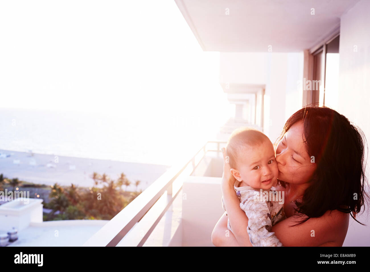 Portrait of mid adult mother and baby son on apartment balcony Stock Photo