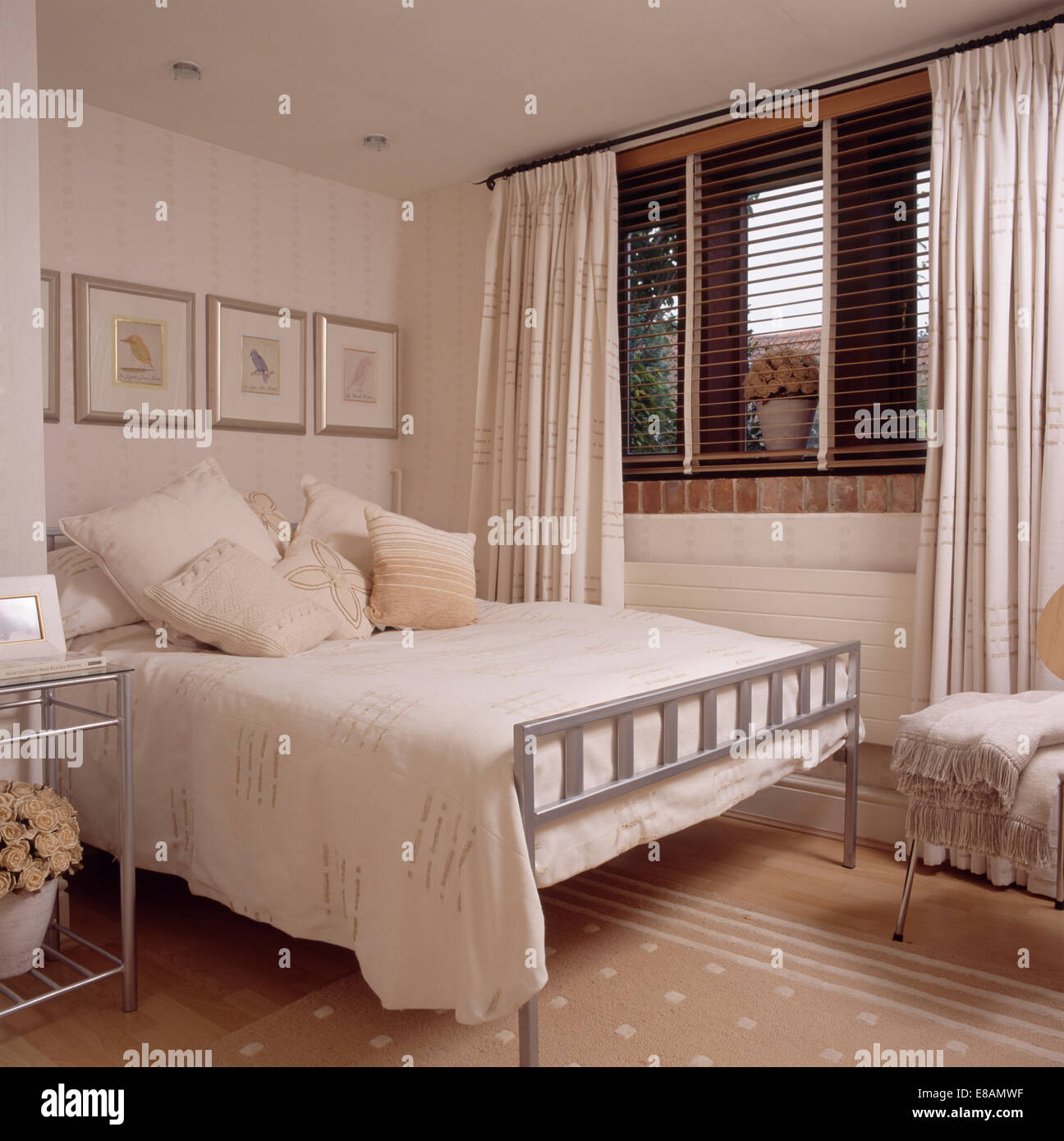 Cream Cushions And Cover On Simple Metal Bed In Modern Bedroom