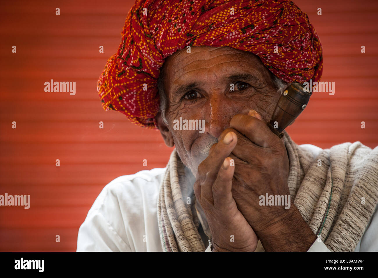 Elderly Indian man smoking traditional pipe Stock Photo