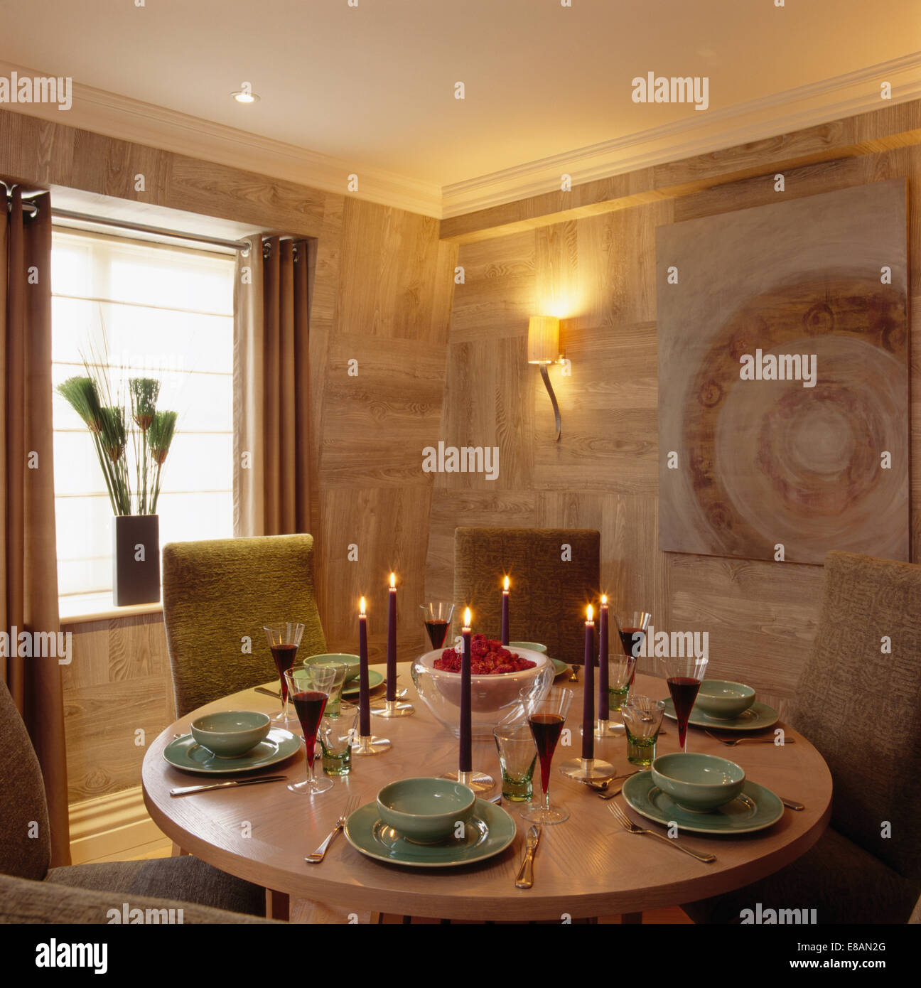 Textured walls in modern apartment dining room with green crockery on ...