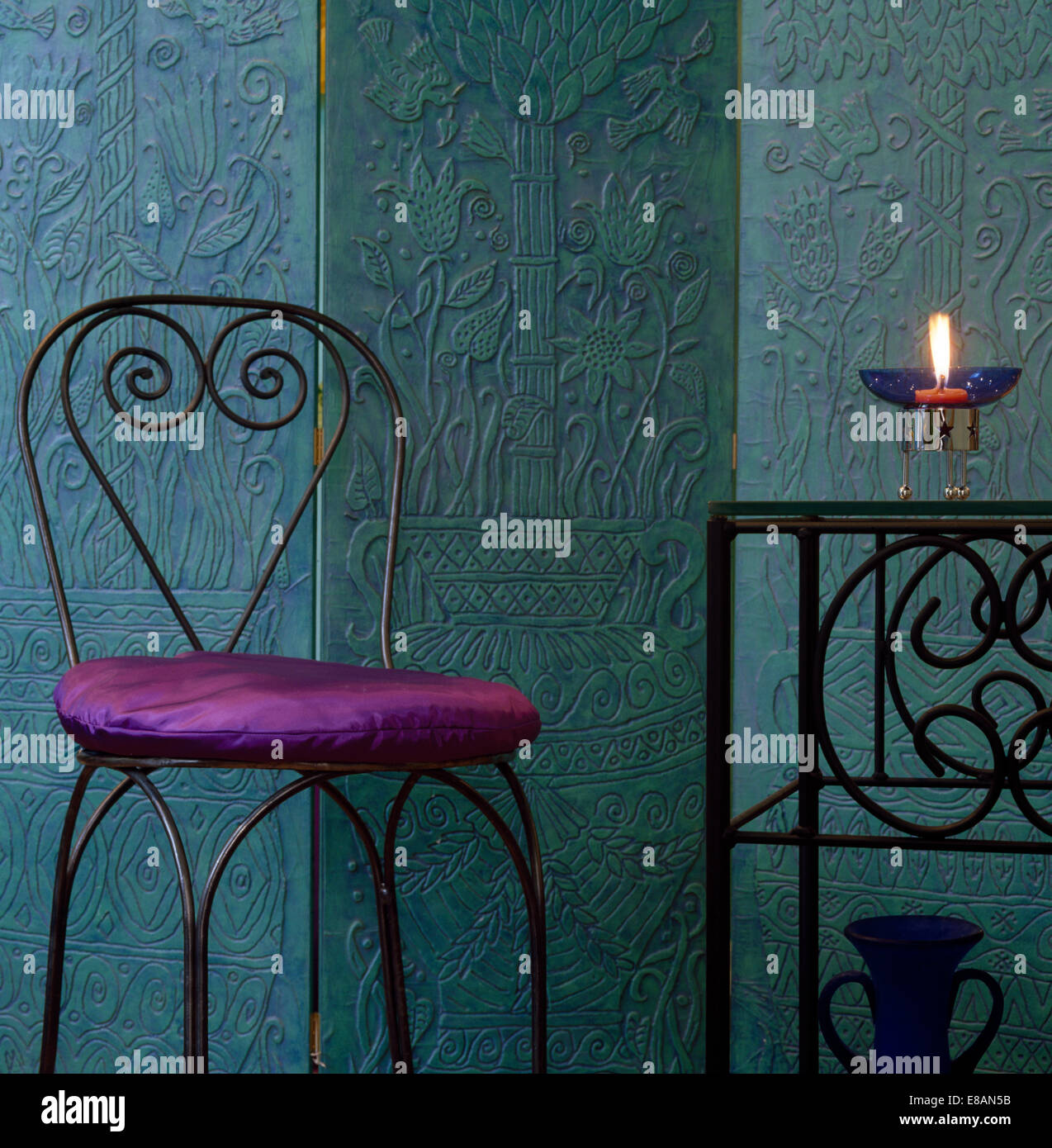 Purple Silk Cushion On Wrought Iron Chair In Front Of Textured