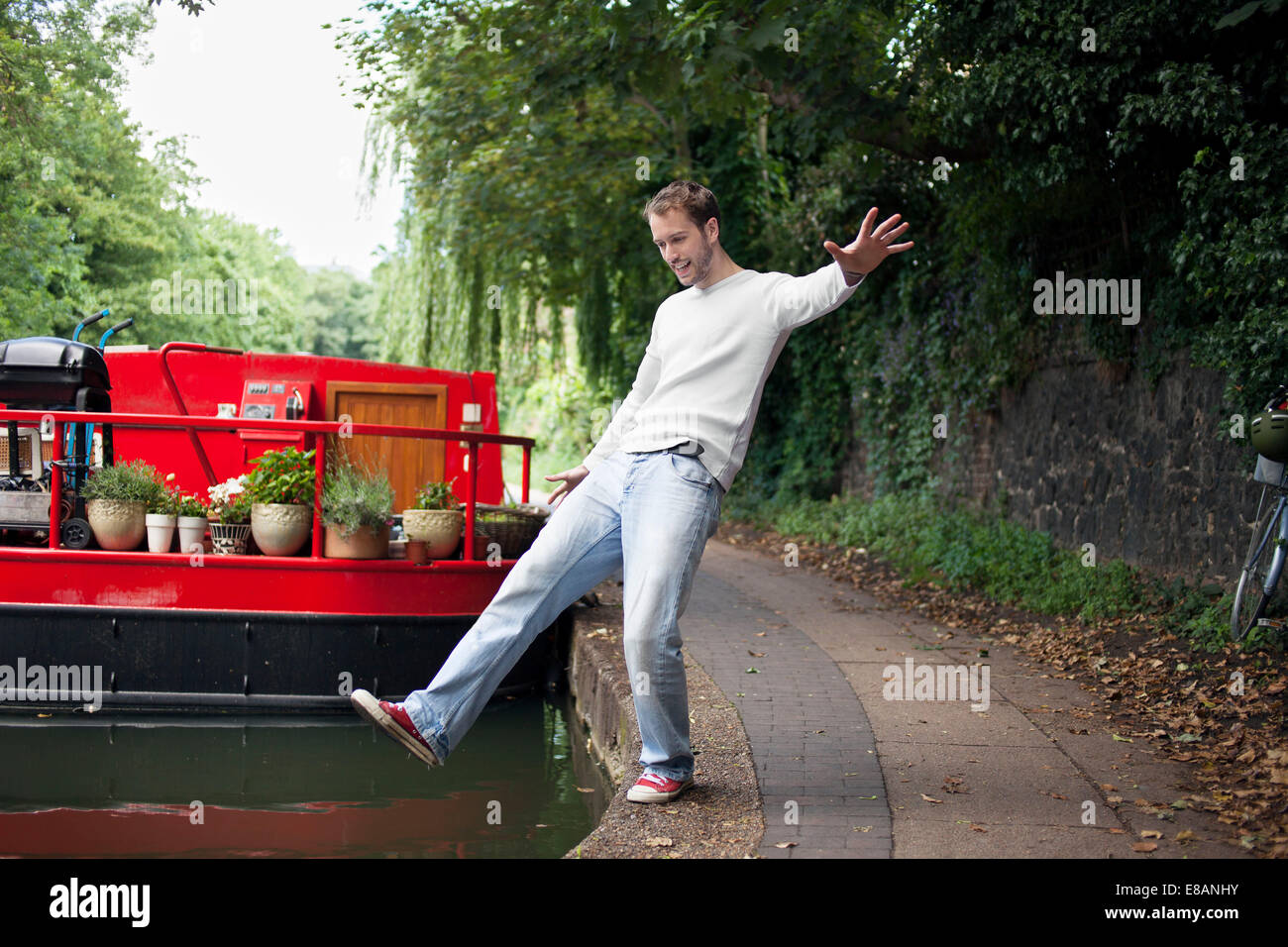 Man pretending to fall into canal , East London, UK Stock Photo