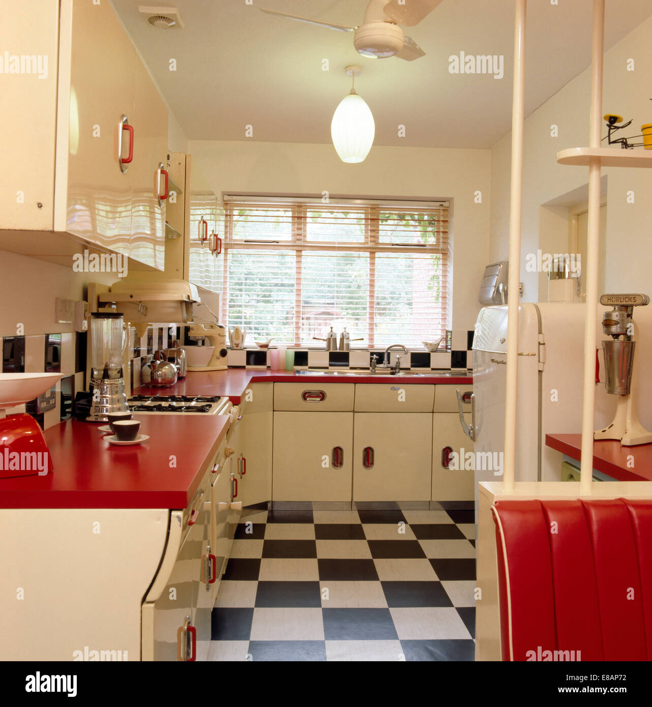 Black White Tiled Vinyl Floor In Fifties Kitchen With Red Worktops