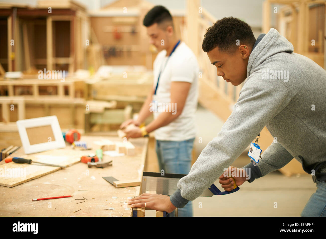 Two male college students in woodworking workshop Stock Photo