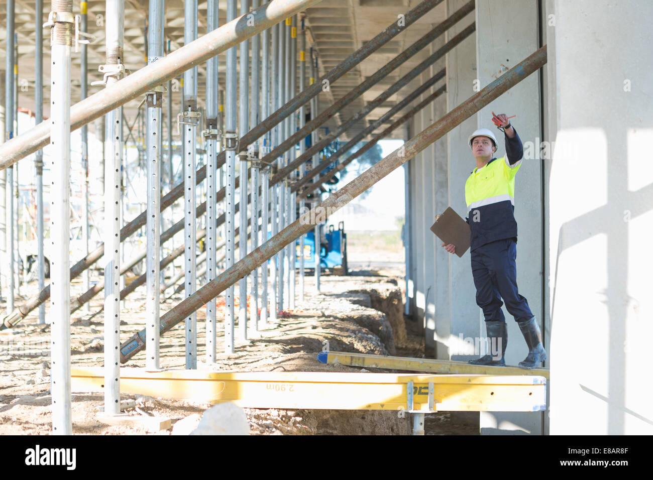 Site manager reaching to checking work on construction site Stock Photo