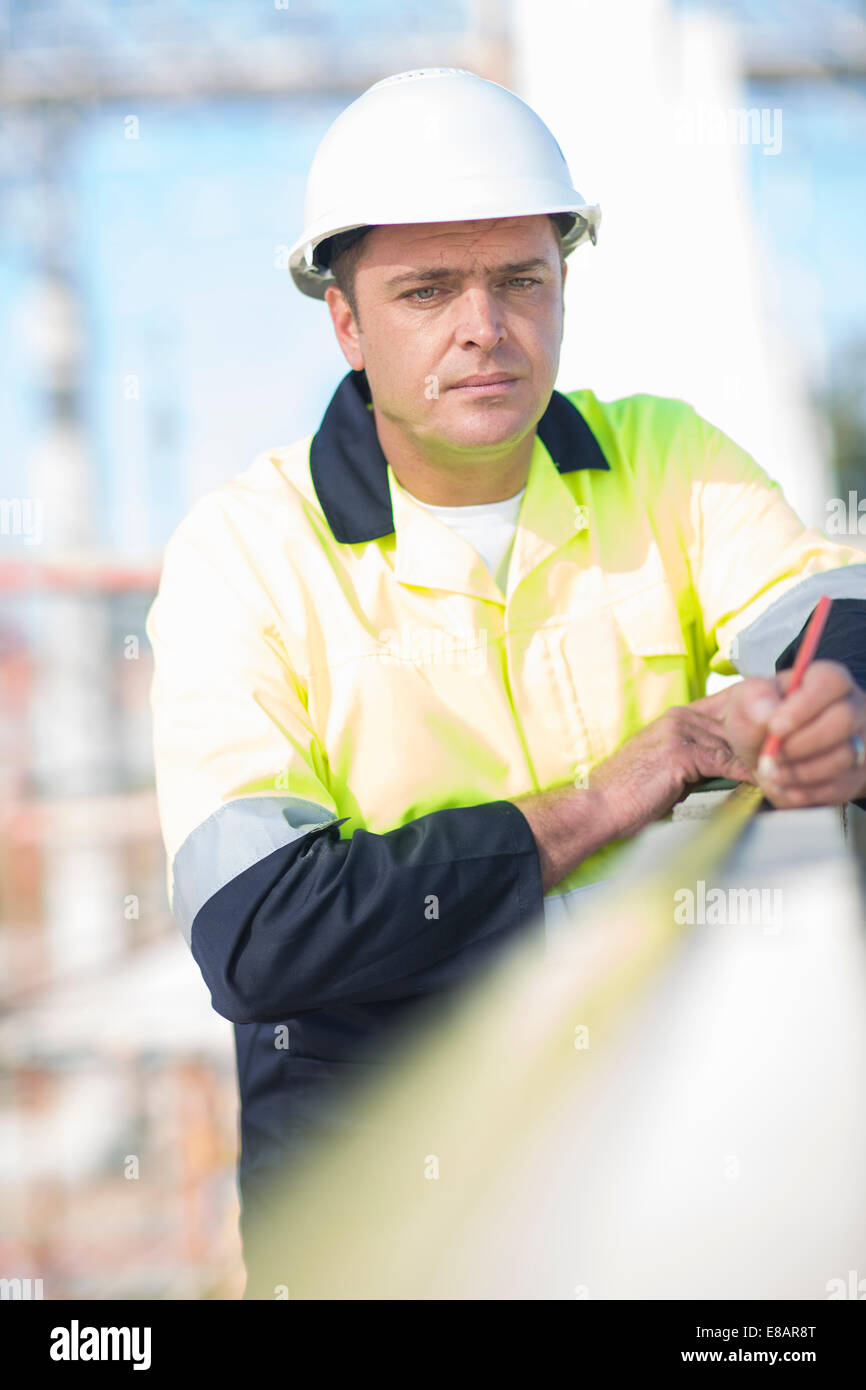 Builders Using Measure Builder using tape measure on construction site wall Stock Photo - Alamy