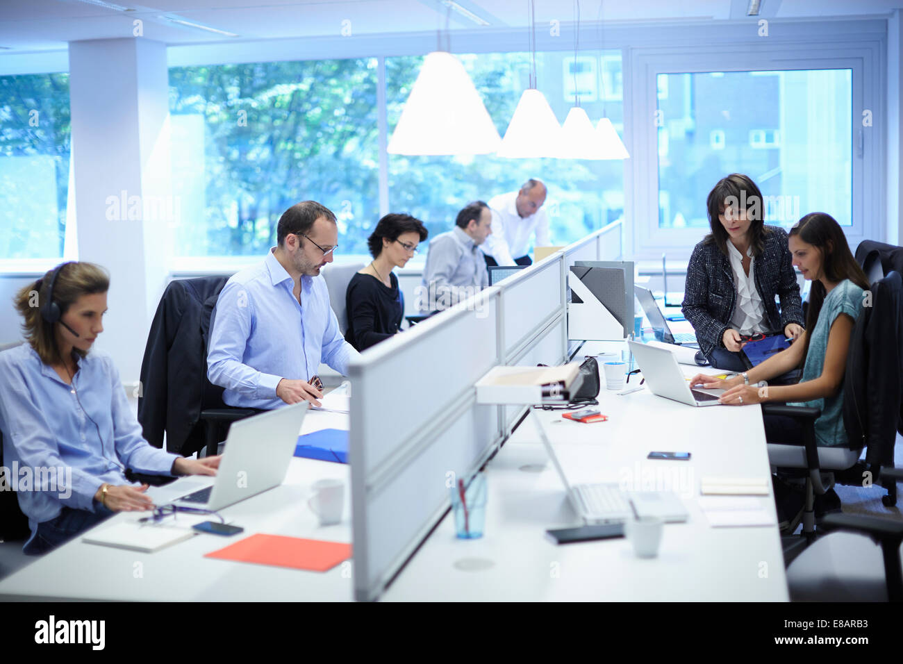 Business team at their desks in busy office Stock Photo