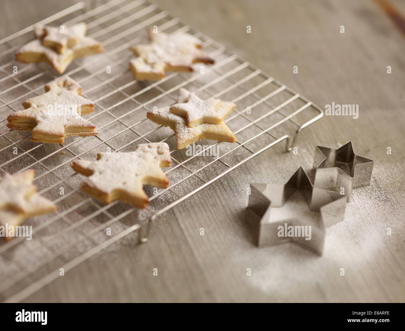 Close up of freshly baked christmas biscuits on cooling rack Stock Photo
