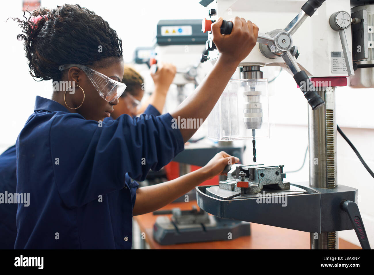 Students using drilling machines in college workshop Stock Photo