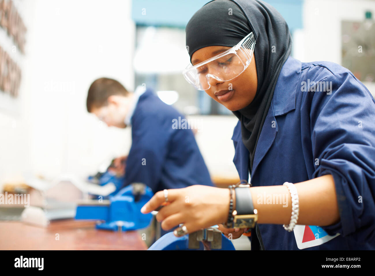 Female student using vice grip in college workshop Stock Photo