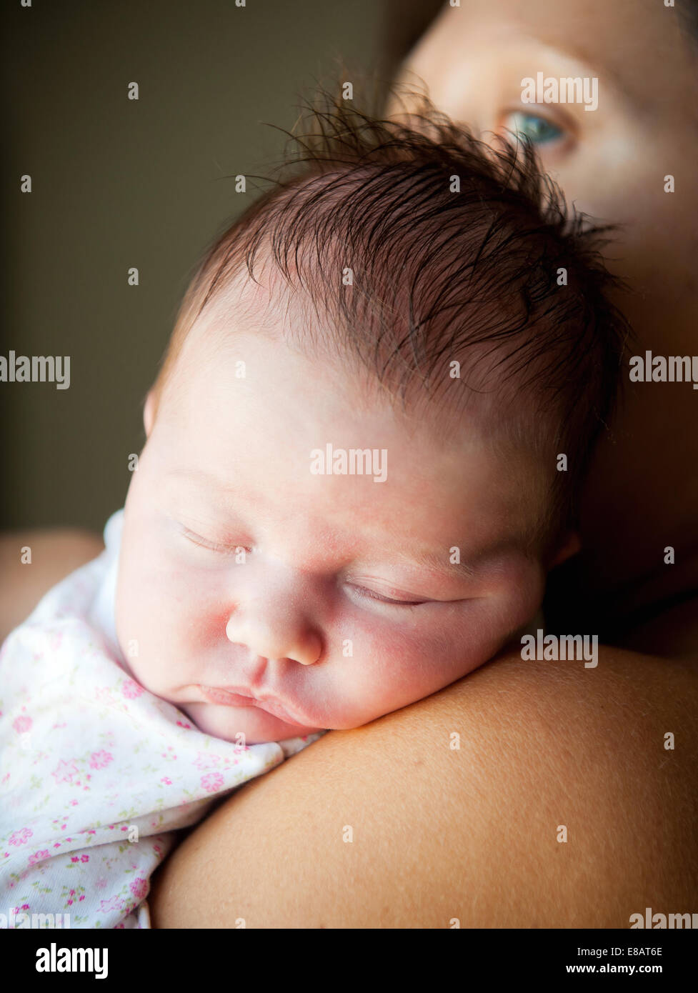 Newborn baby in the arms of his mother Stock Photo