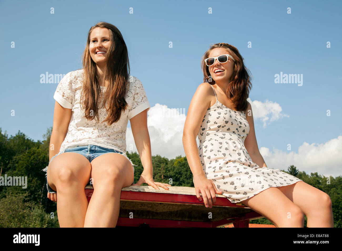 Two young women sitting in trailer Stock Photo