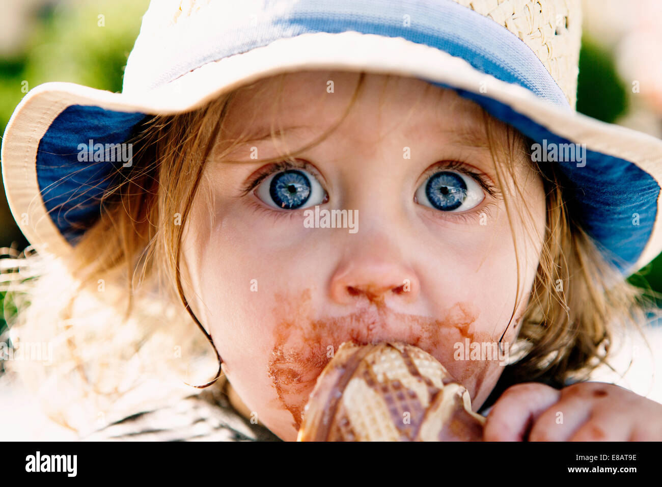 Young girl eating ice cream cone Stock Photo