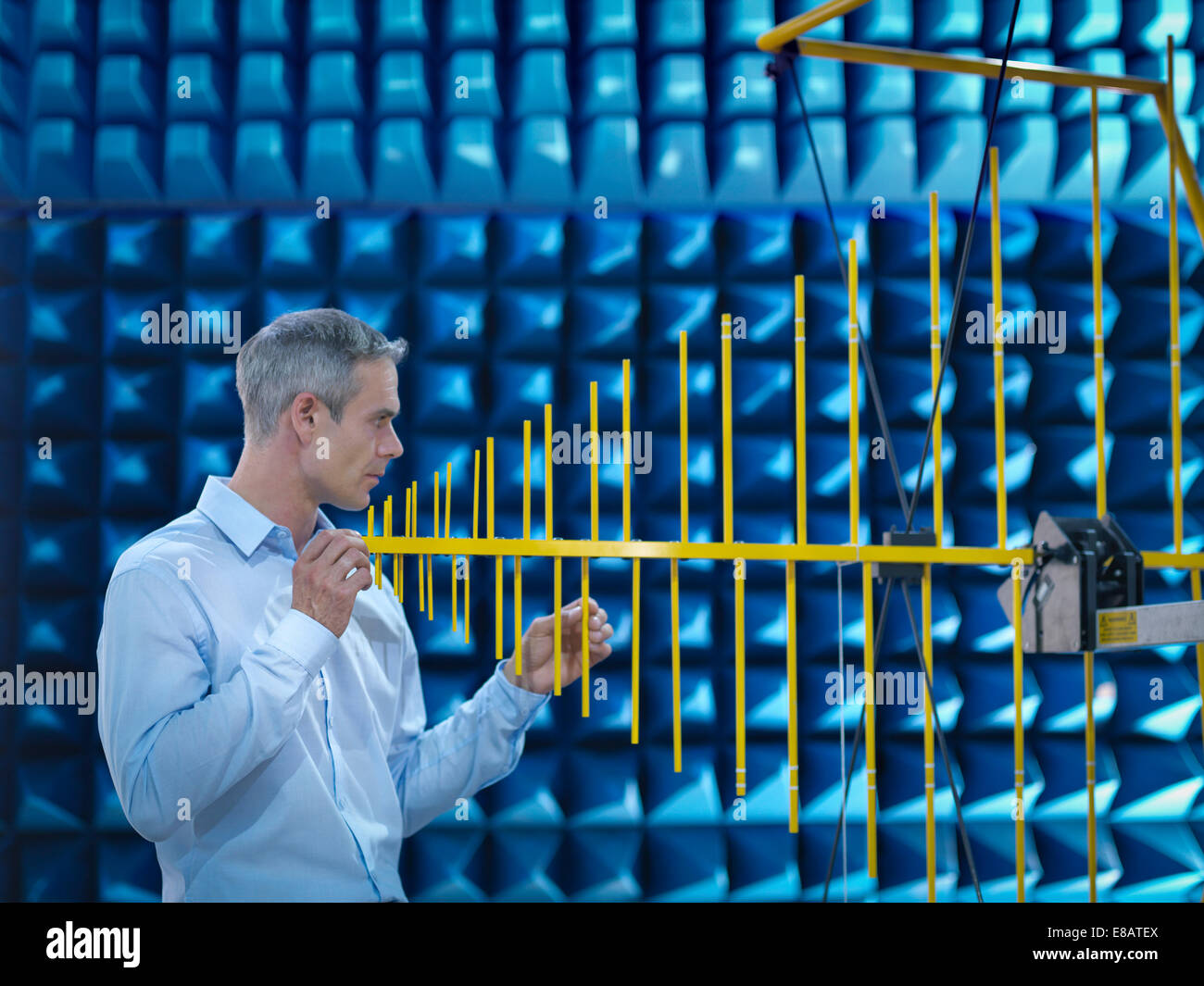 Scientist preparing to measure electromagnetic waves in anechoic chamber Stock Photo