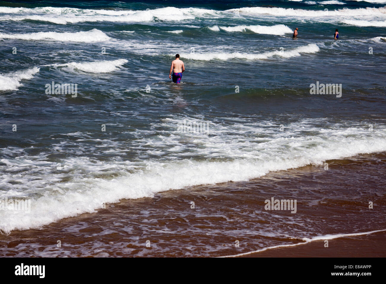 Brave swimmers in a rough sea Stock Photo