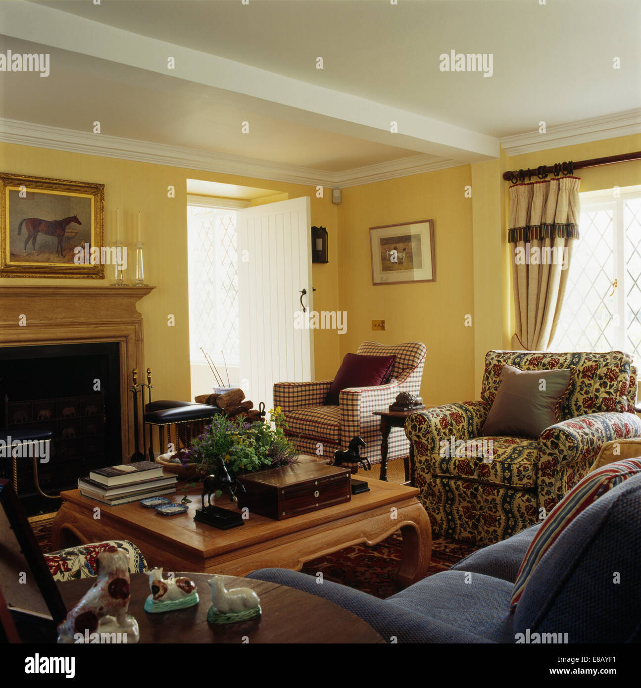 Comfortable sofa and armchairs in yellow country living room Stock