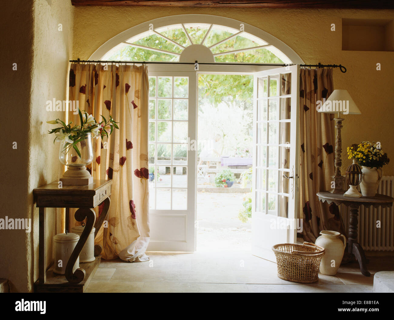 French Country Hall With Patterned Cream Curtain On Half