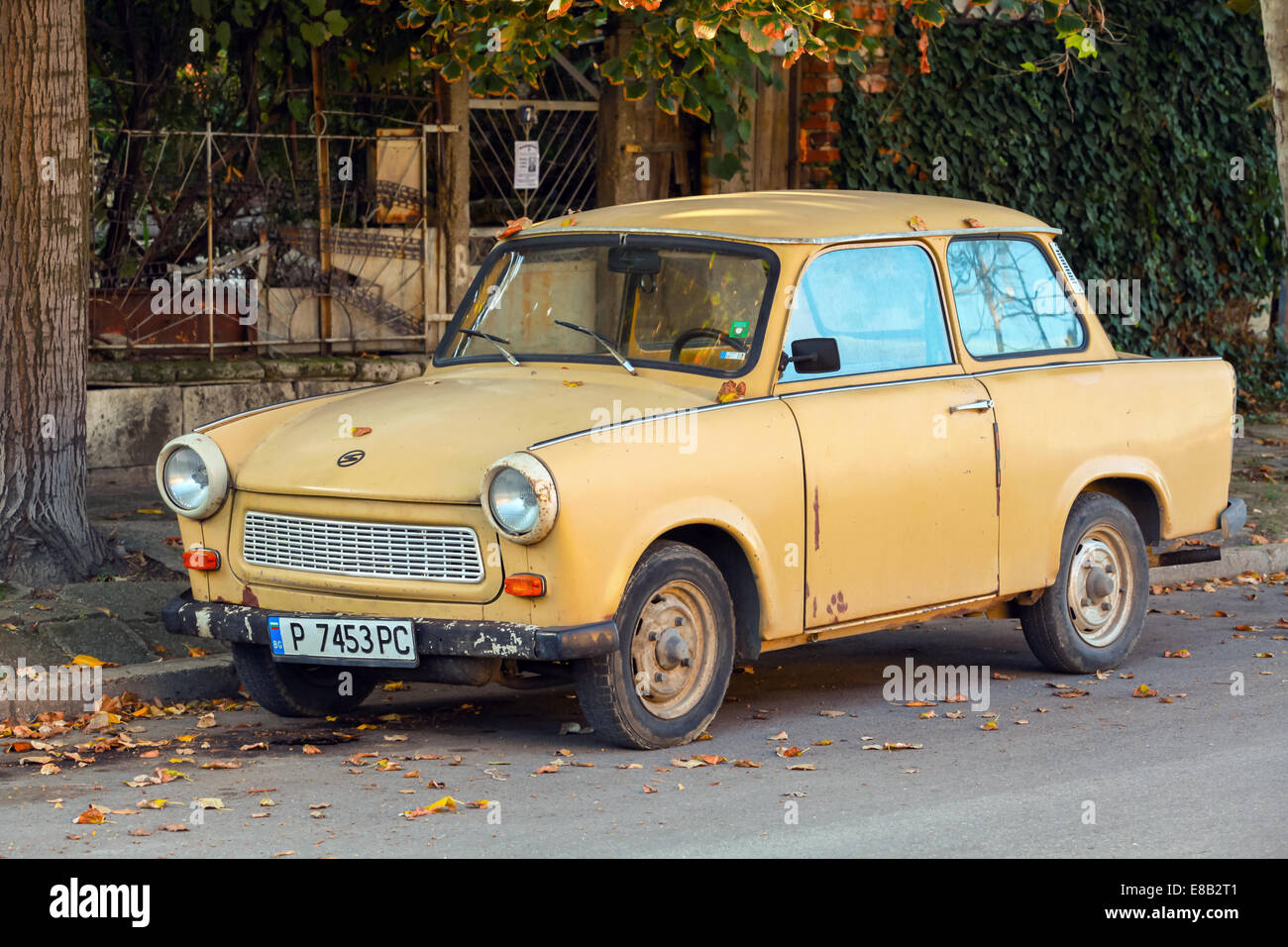 RUSE, BULGARIA - SEPTEMBER 29, 2014: Old yellow Trabant 601s car stands parked on a street side. It was the most common vehicle Stock Photo