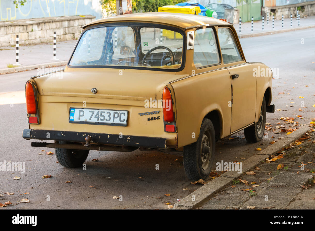 RUSE, BULGARIA - SEPTEMBER 29, 2014: Old yellow Trabant 601s car stands parked on a street side. It was the most common vehicle Stock Photo